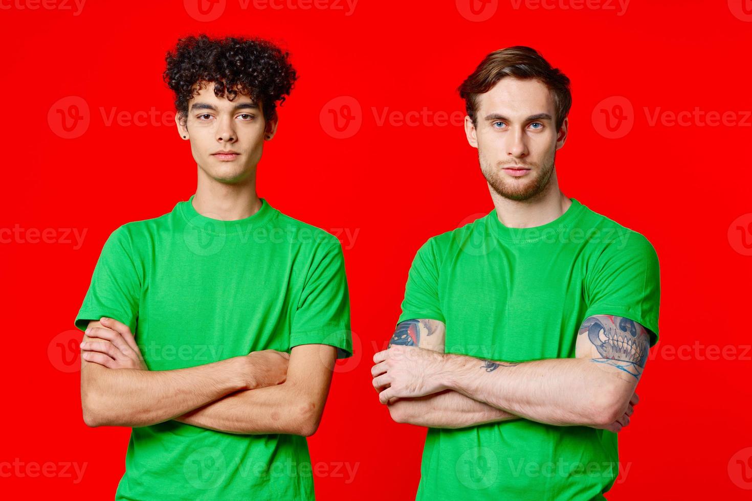 two men in green t-shirts stand next to communication Friendship photo