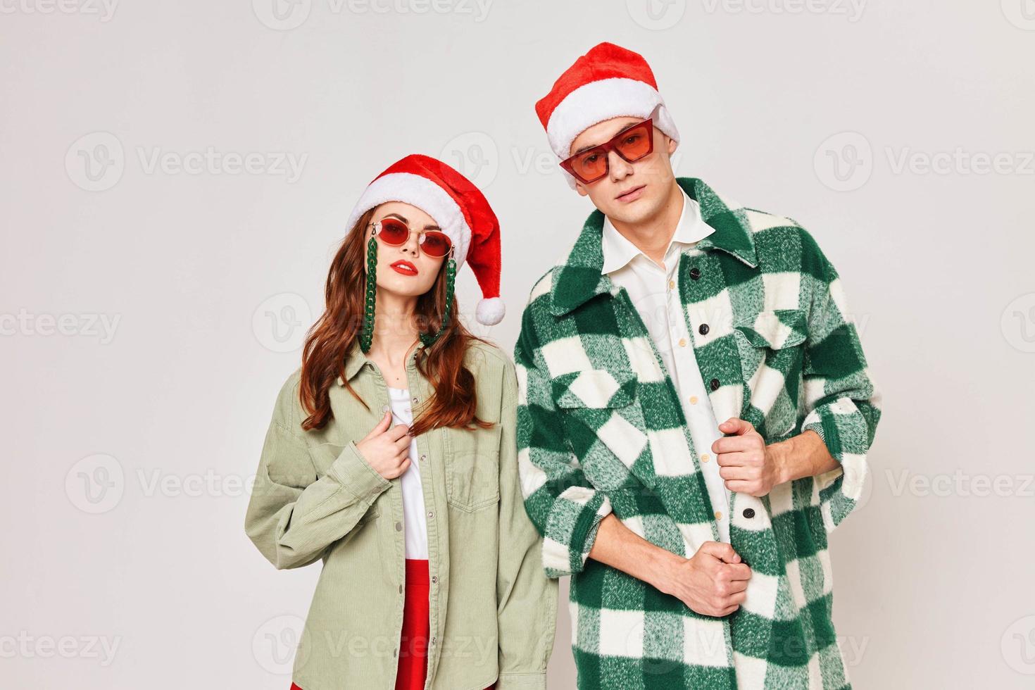 Cute couple are standing together. Christmas fashion with sunglasses photo