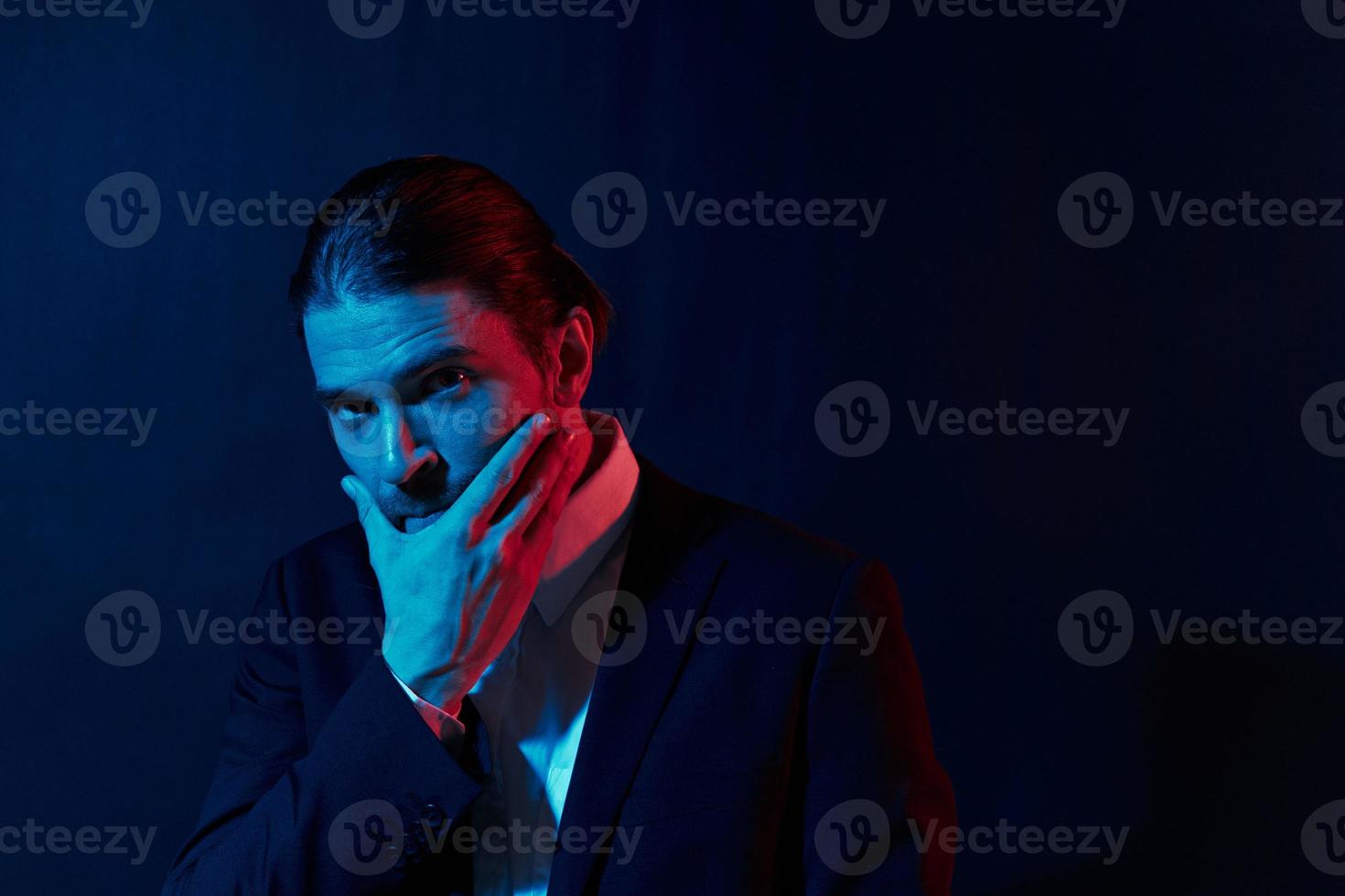 handsome man in costume posing fashion neon light photo