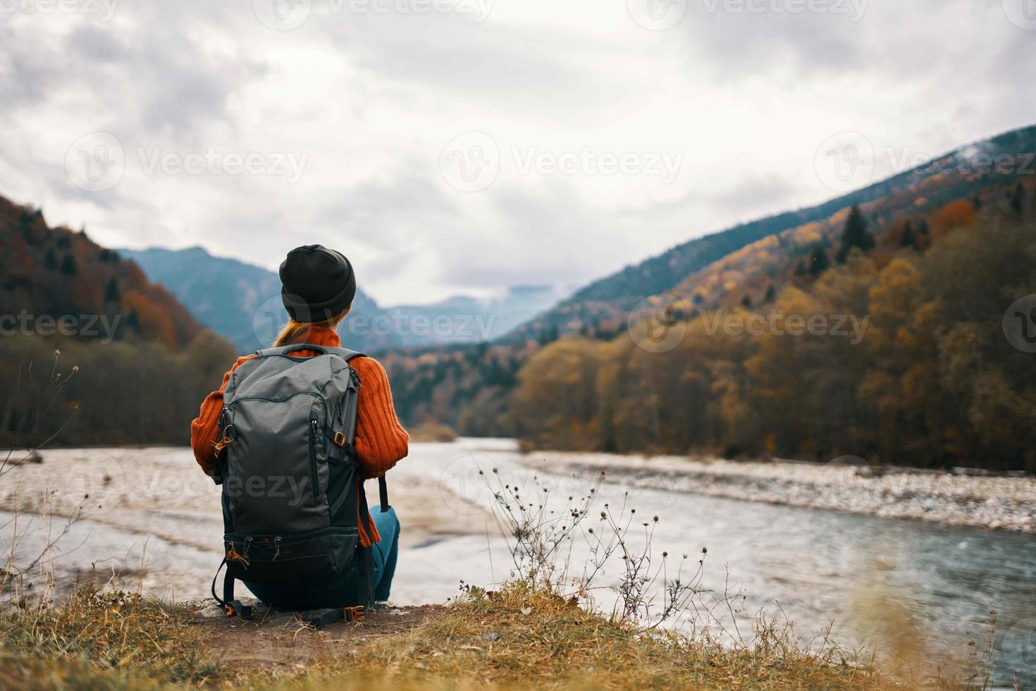 woman hiker walks near the river mountains nature travel photo