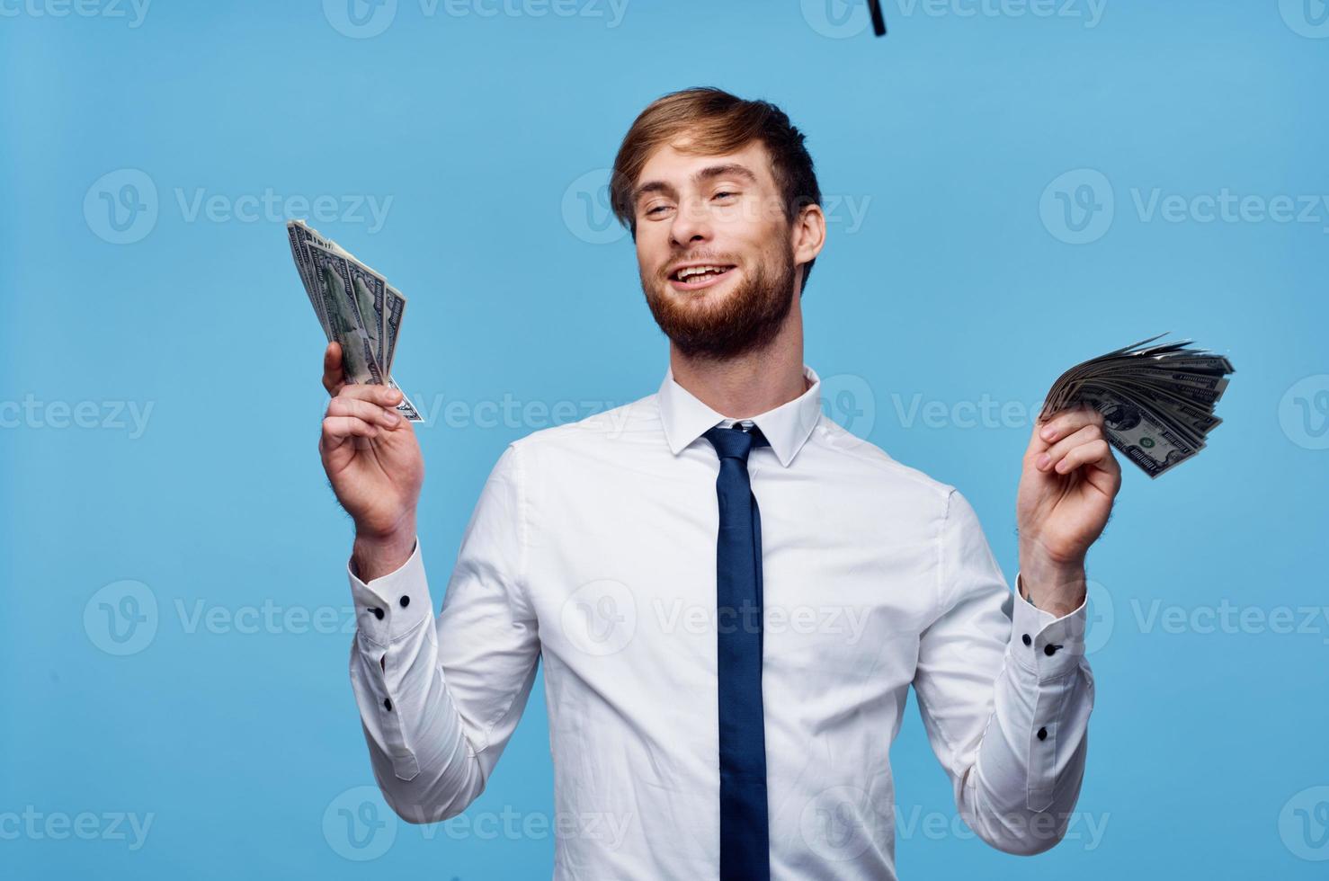 Cheerful man with wads of money in his hands success rich man photo