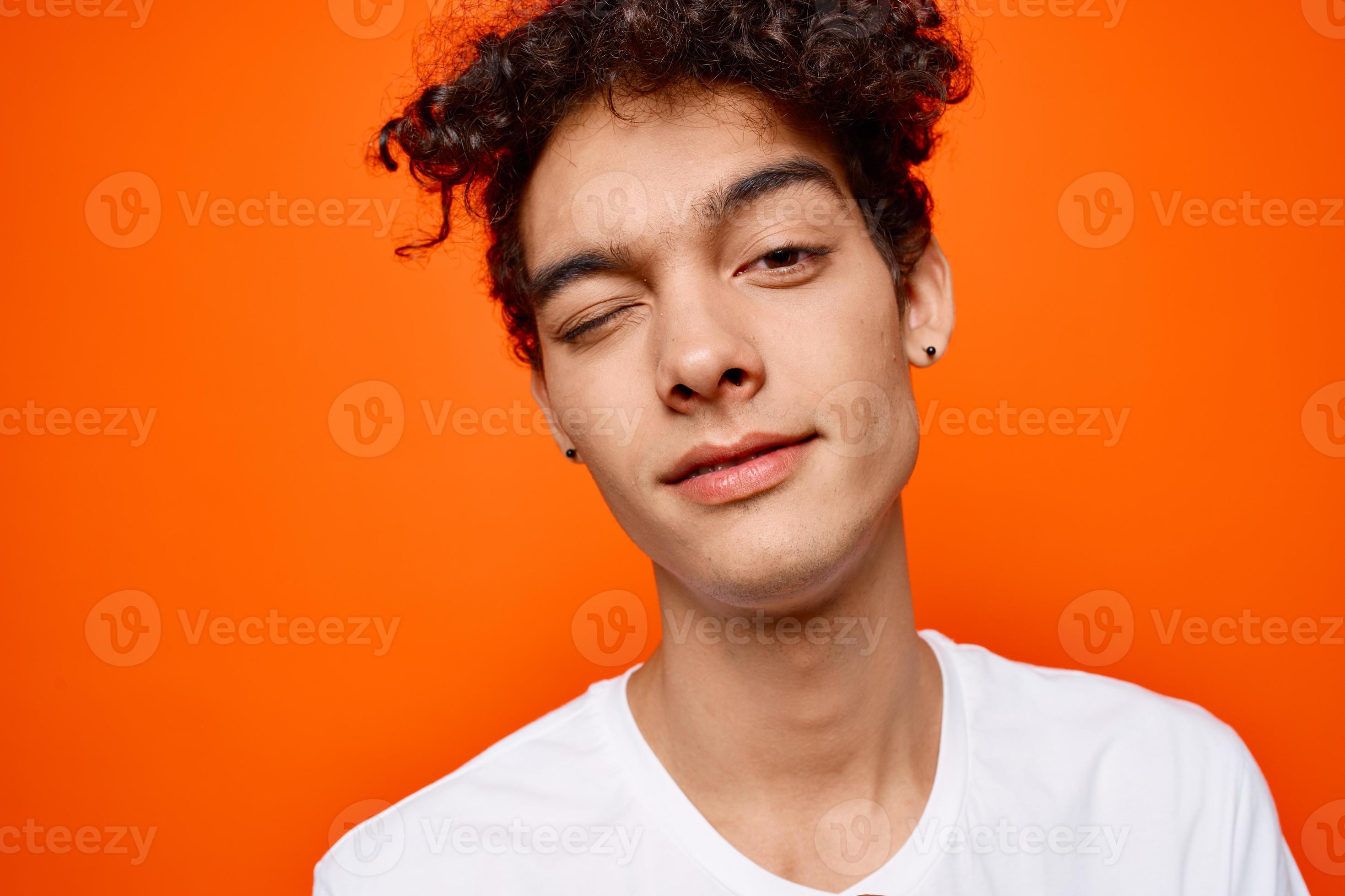 guy with curly hair in a white tshirt emotion grimace 21994394 Stock