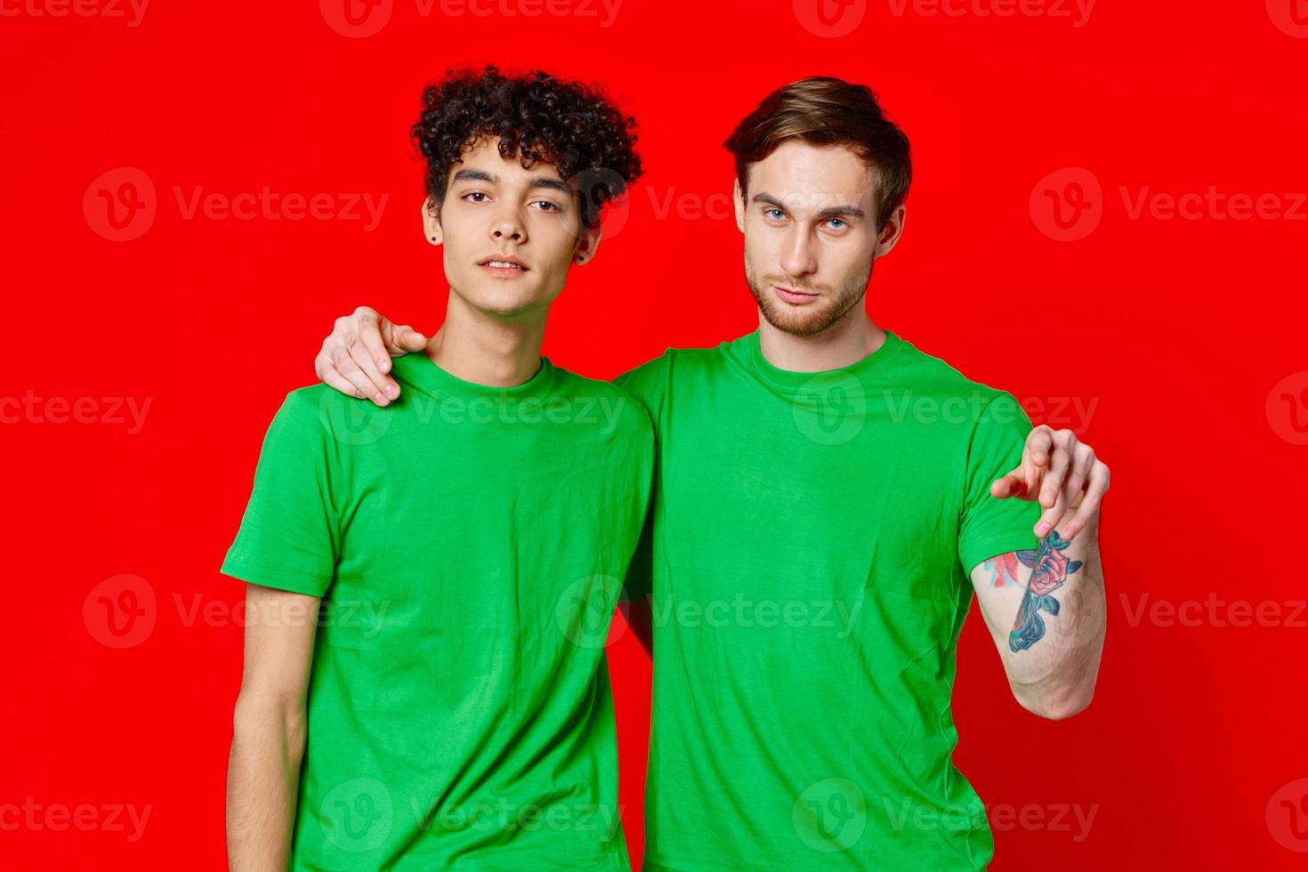 Two cheerful friends hug green t-shirts emotions photo