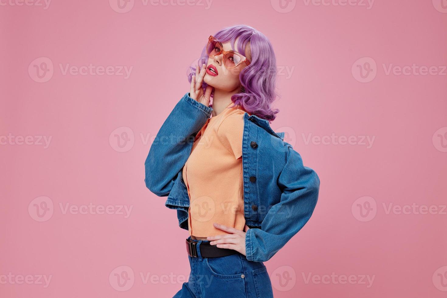 Portrait of a charming lady denim clothing fashion posing cap pink glasses pink background unaltered photo