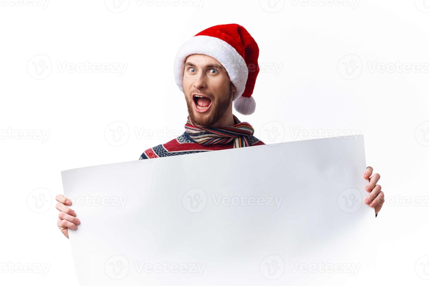 handsome man in a christmas hat with white mockup poster christmas copy-space studio photo