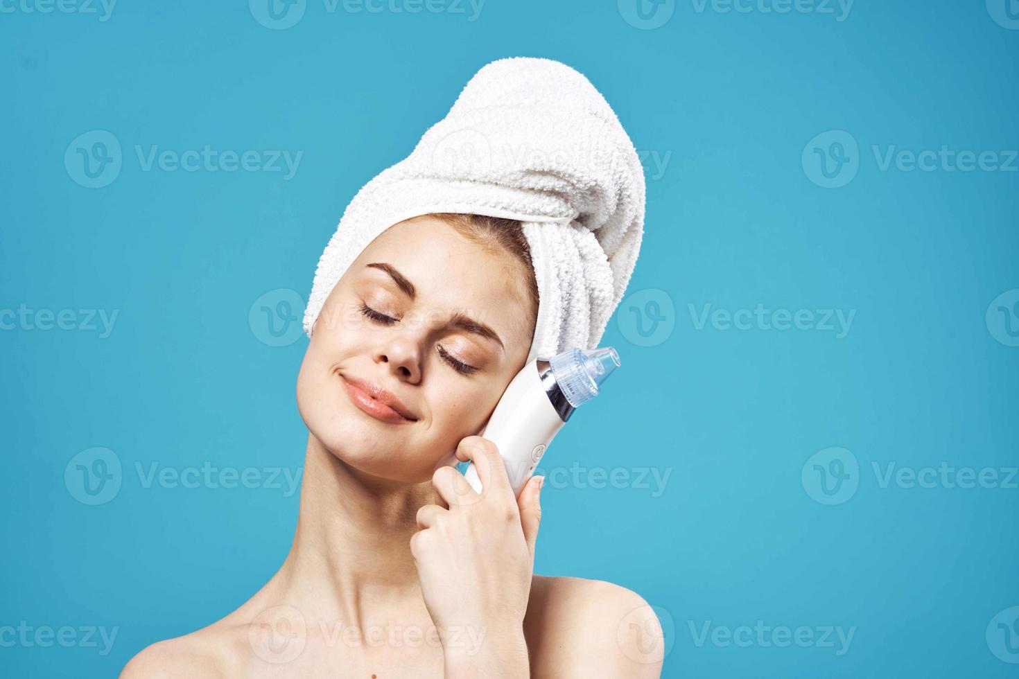 pretty woman with bare shoulders towel on head spa treatments massager photo