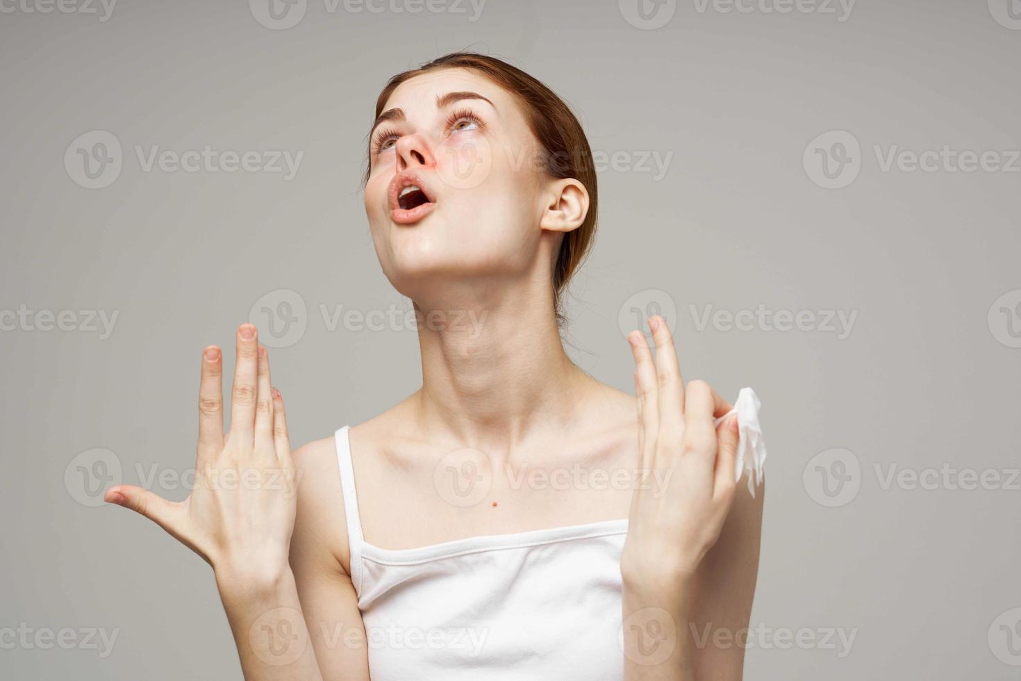 sick woman in white t-shirt with a scarf isolated background photo