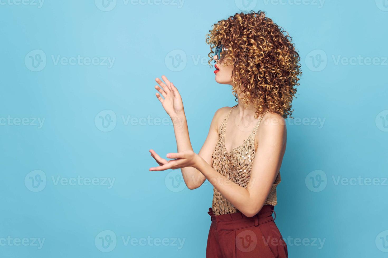 Charming model Curly hair lifestyle studio side view gesturing with hands fashion clothes photo