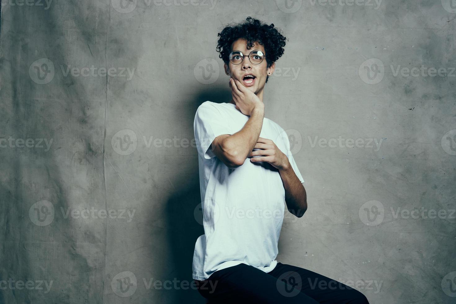 cute guy with curly hair in white t-shirt glasses fashion photo