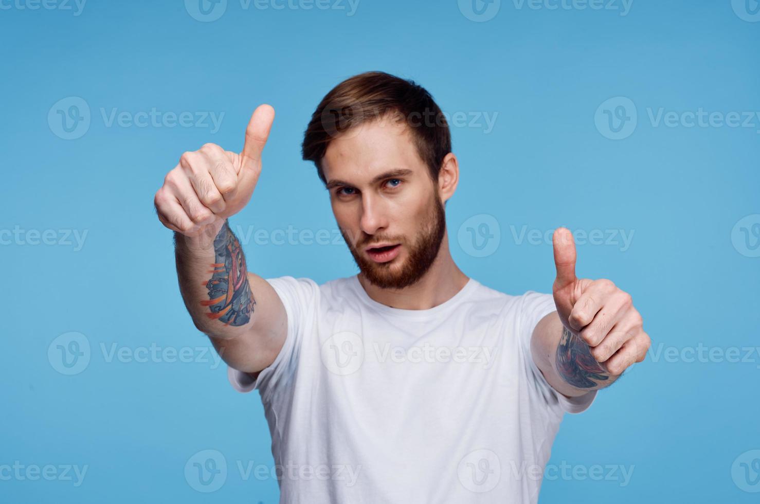 Cheerful man in white t-shirt tattoo on his arms cropped view fashion photo