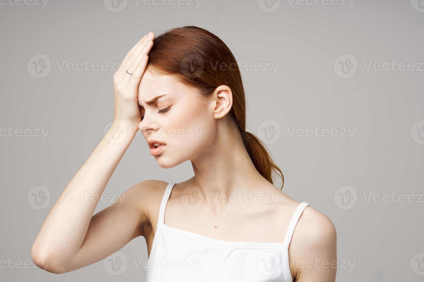 woman holding head migraine disorder studio treatment photo