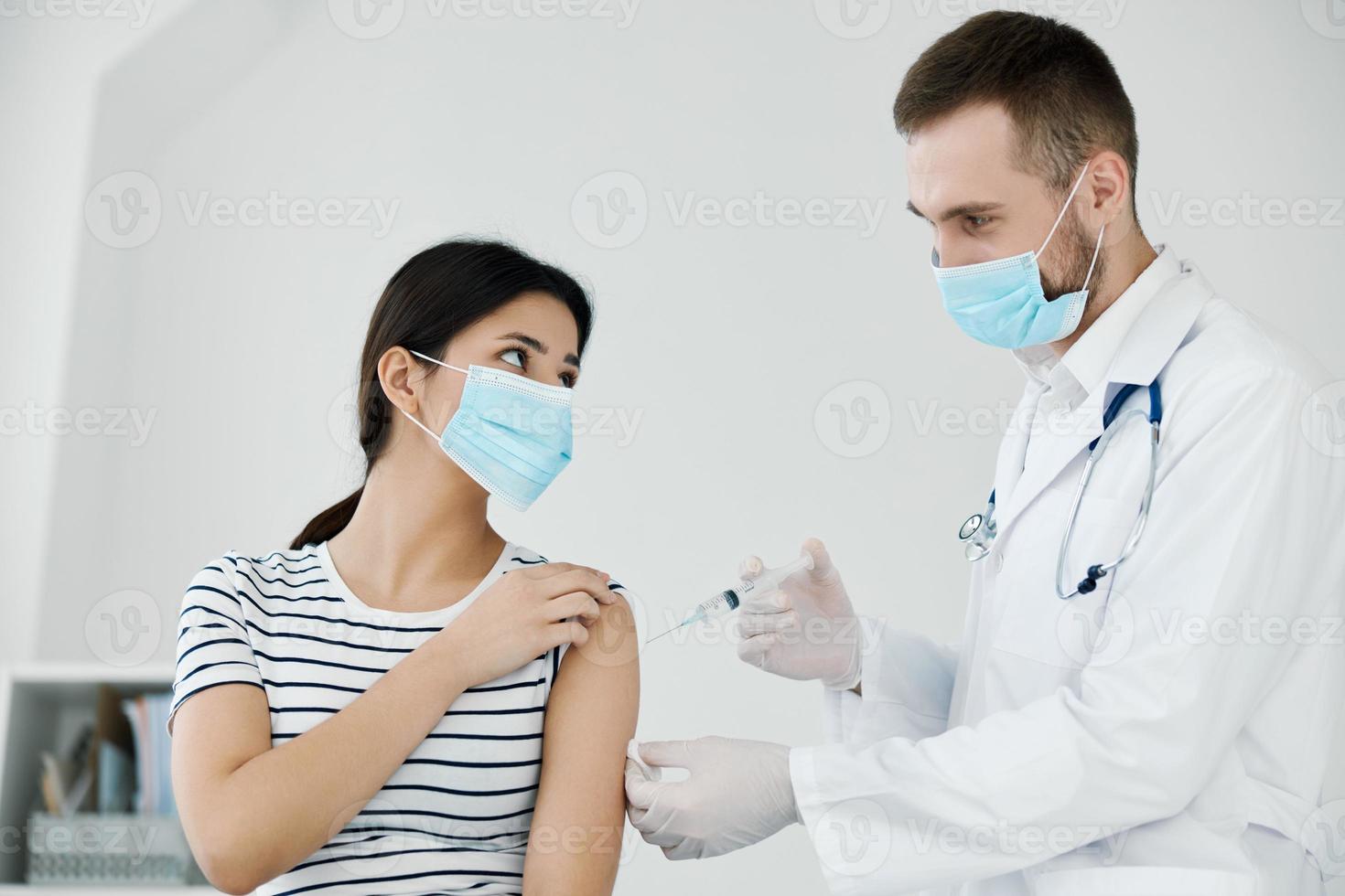 male doctor injects vaccine into shoulder health coronavirus photo