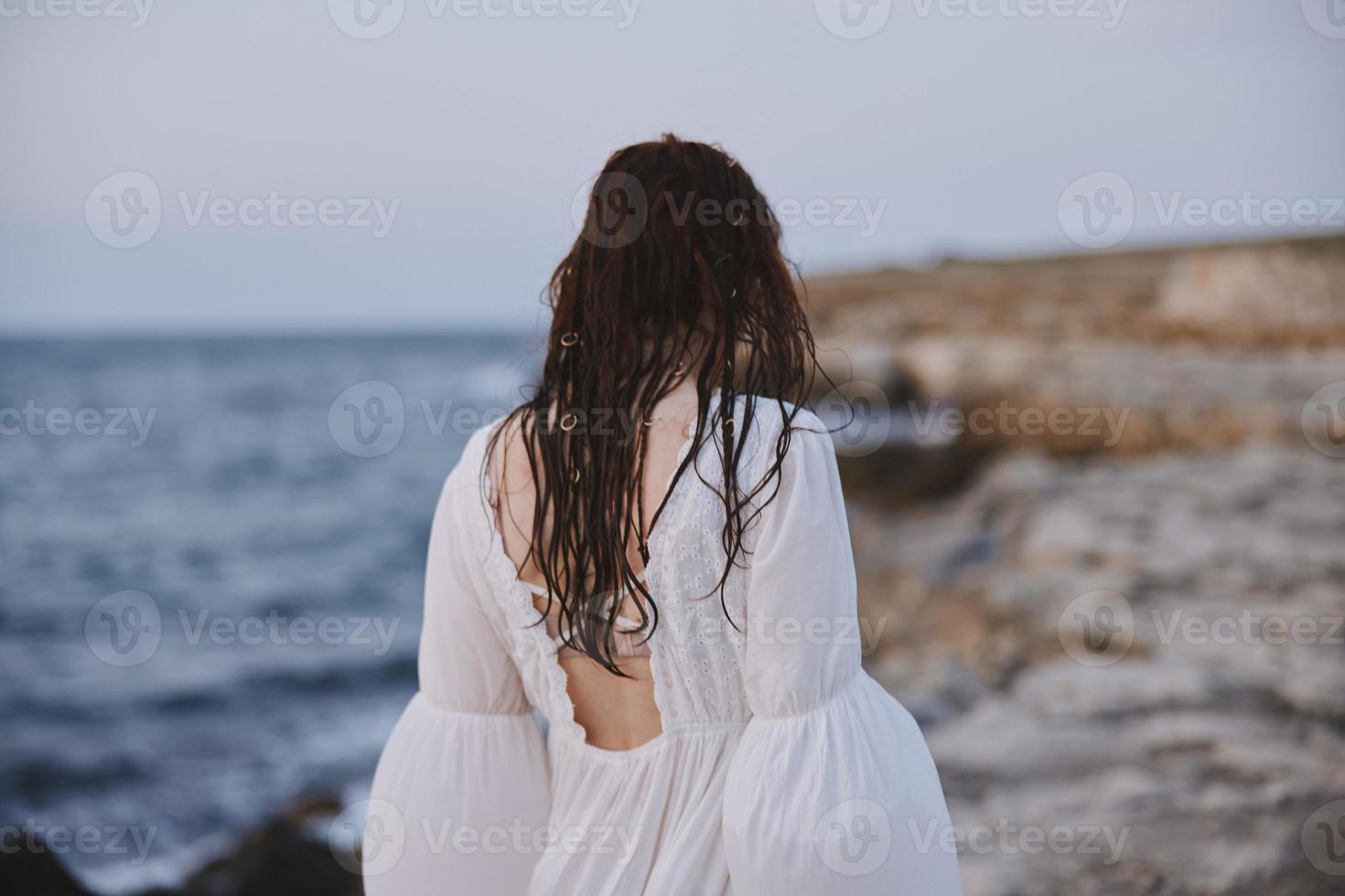 Woman outdoors landscape ocean stones travel unaltered photo