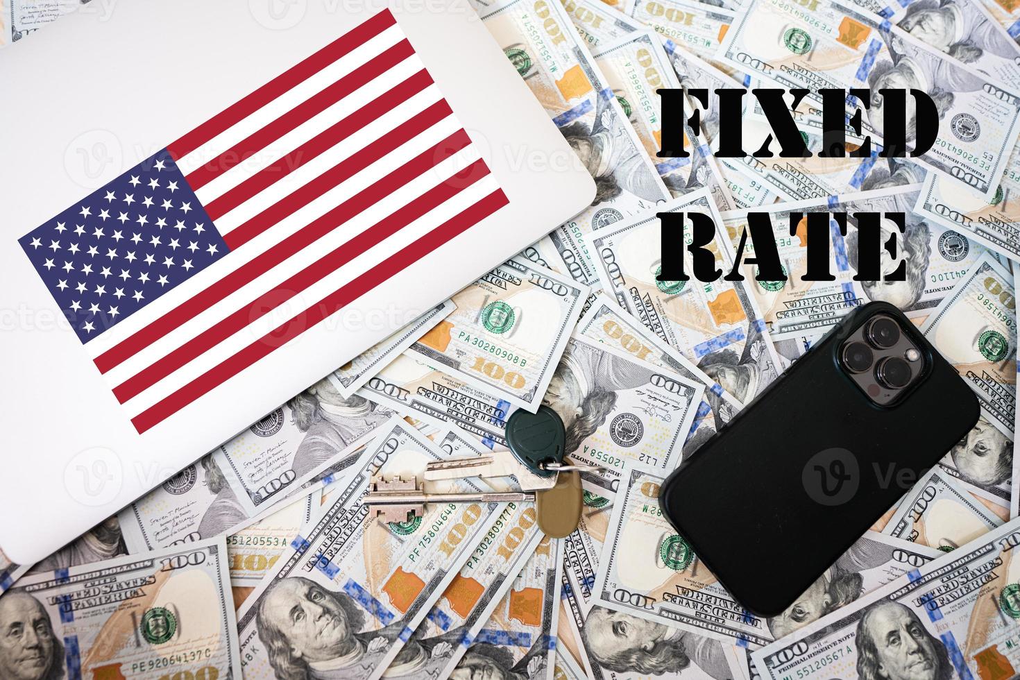 Fixed rate concept. USA flag, dollar money with keys, laptop and phone background. photo