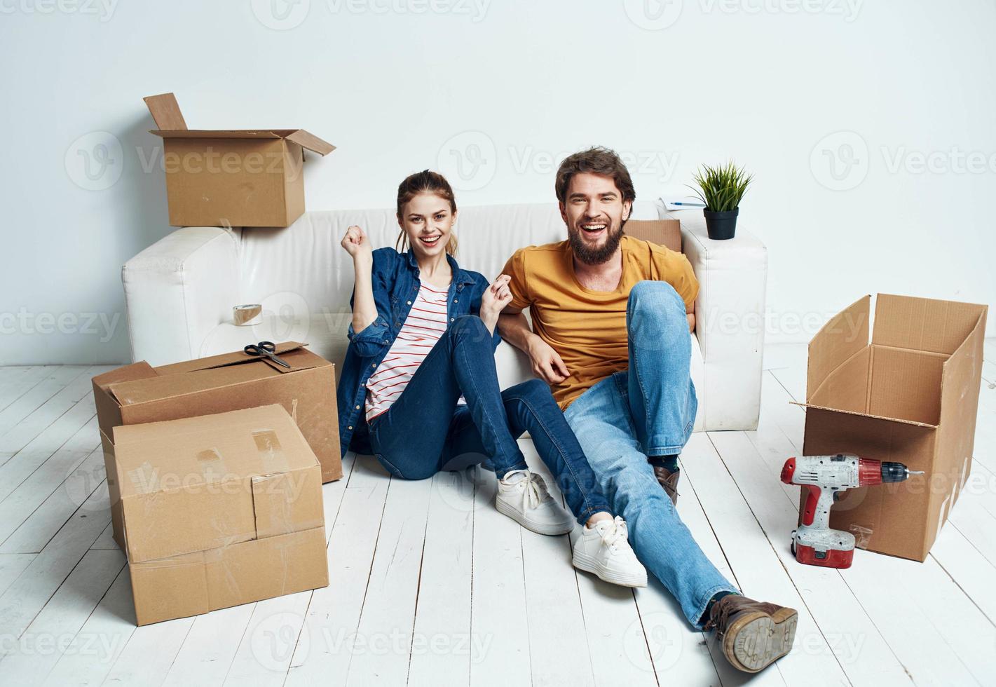 Man and woman with empty boxes Moving to an apartment indoor interior