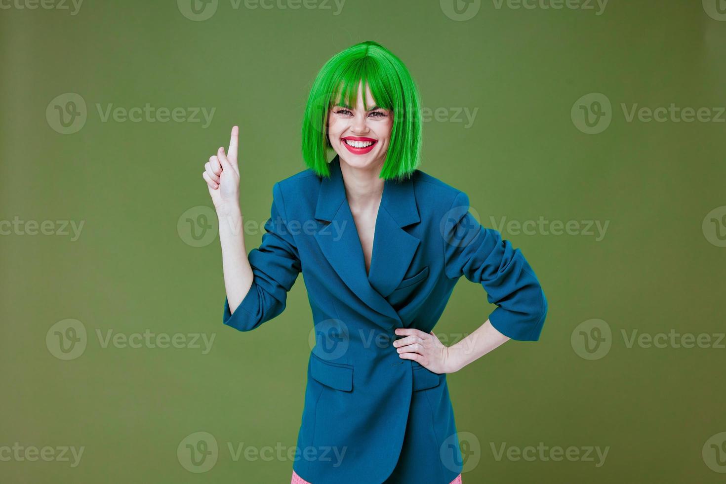 Pretty young female wearing a green wig blue jacket posing color background unaltered photo