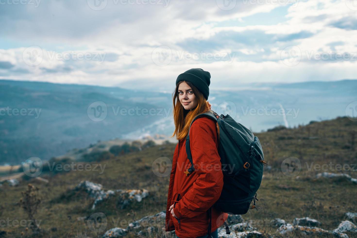 portrait of a traveler in the mountains in nature rock landscape clouds sky model photo