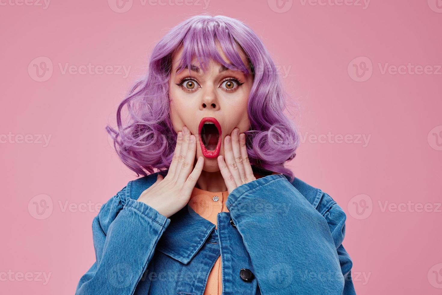 Positive young woman wavy purple hair blue jacket emotions fun studio model unaltered very peri photo