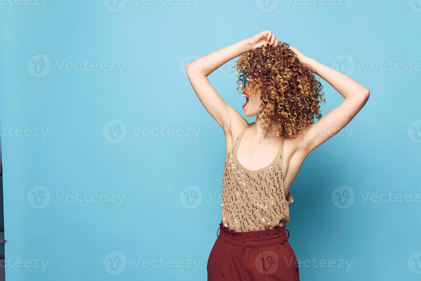 woman curly hair Fun dance charm lifestyle blue background photo