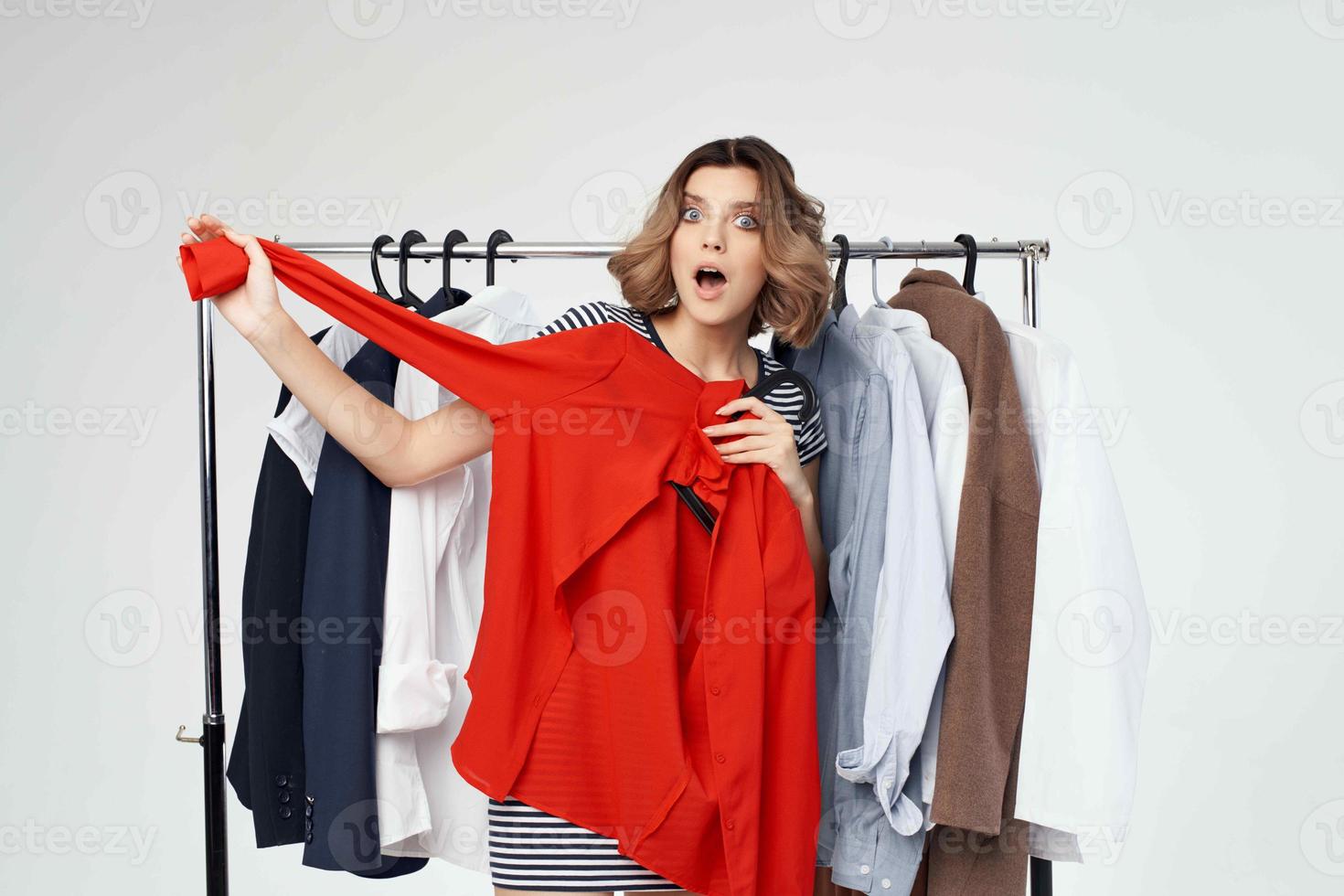 beautiful woman near clothes shopaholic isolated background photo