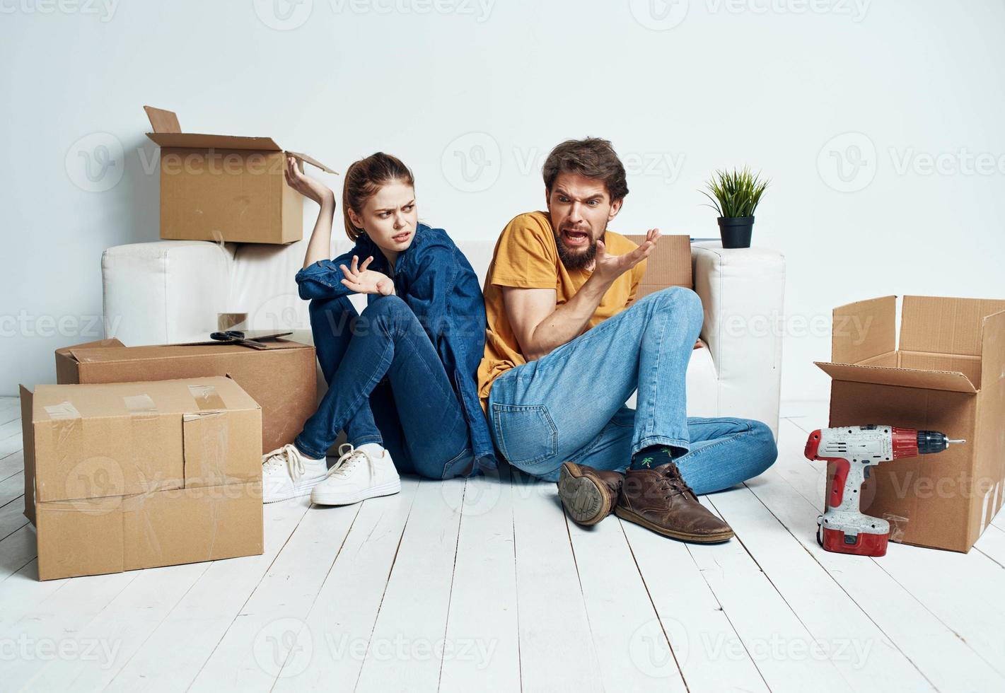 man and woman moving apartment flower potted and boxes repair tools photo