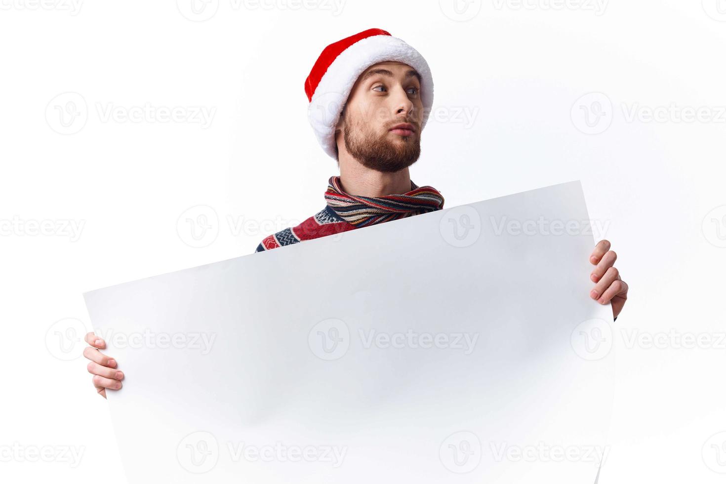 emotional man in a christmas hat with white mockup poster christmas isolated background photo