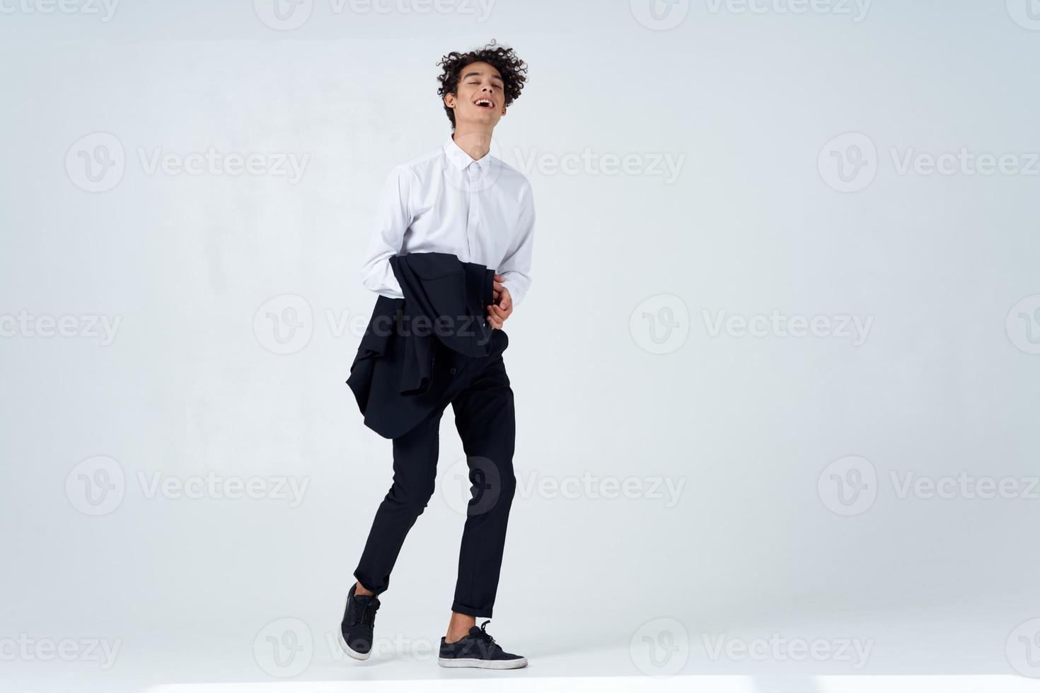 curly guy in suit jacket in hands posing lifestyle modern style photo