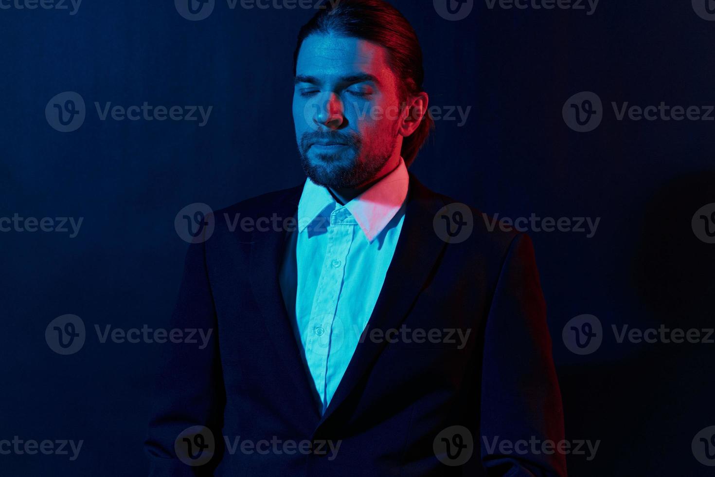 stylish man in a jacket posing self confidence dark background photo