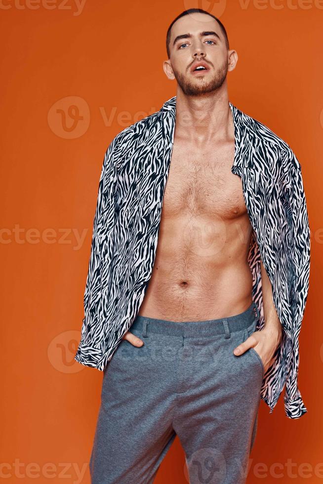 handsome man in shirt nude torso posing fashion orange background photo