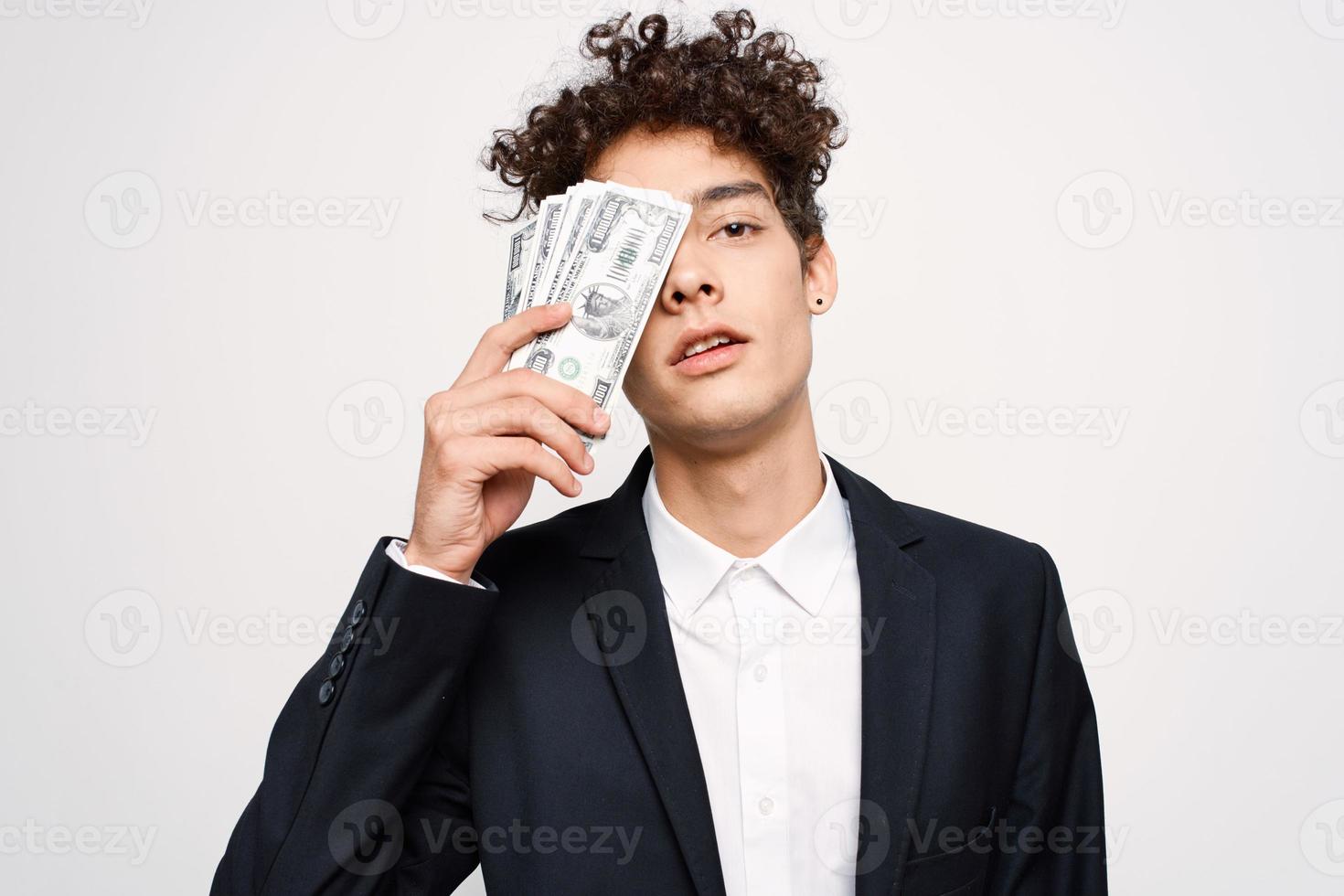 man in a suit a bundle of money in the hands of a businessman self-confidence photo