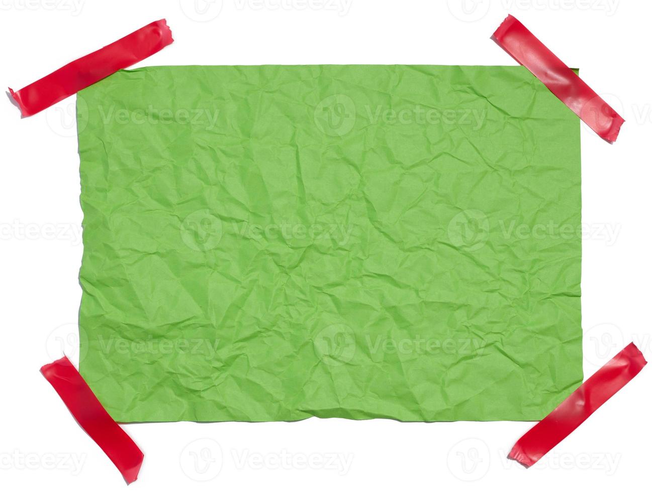 Crumpled rectangular sheet of green paper on a white background, top view. Place for inscription photo