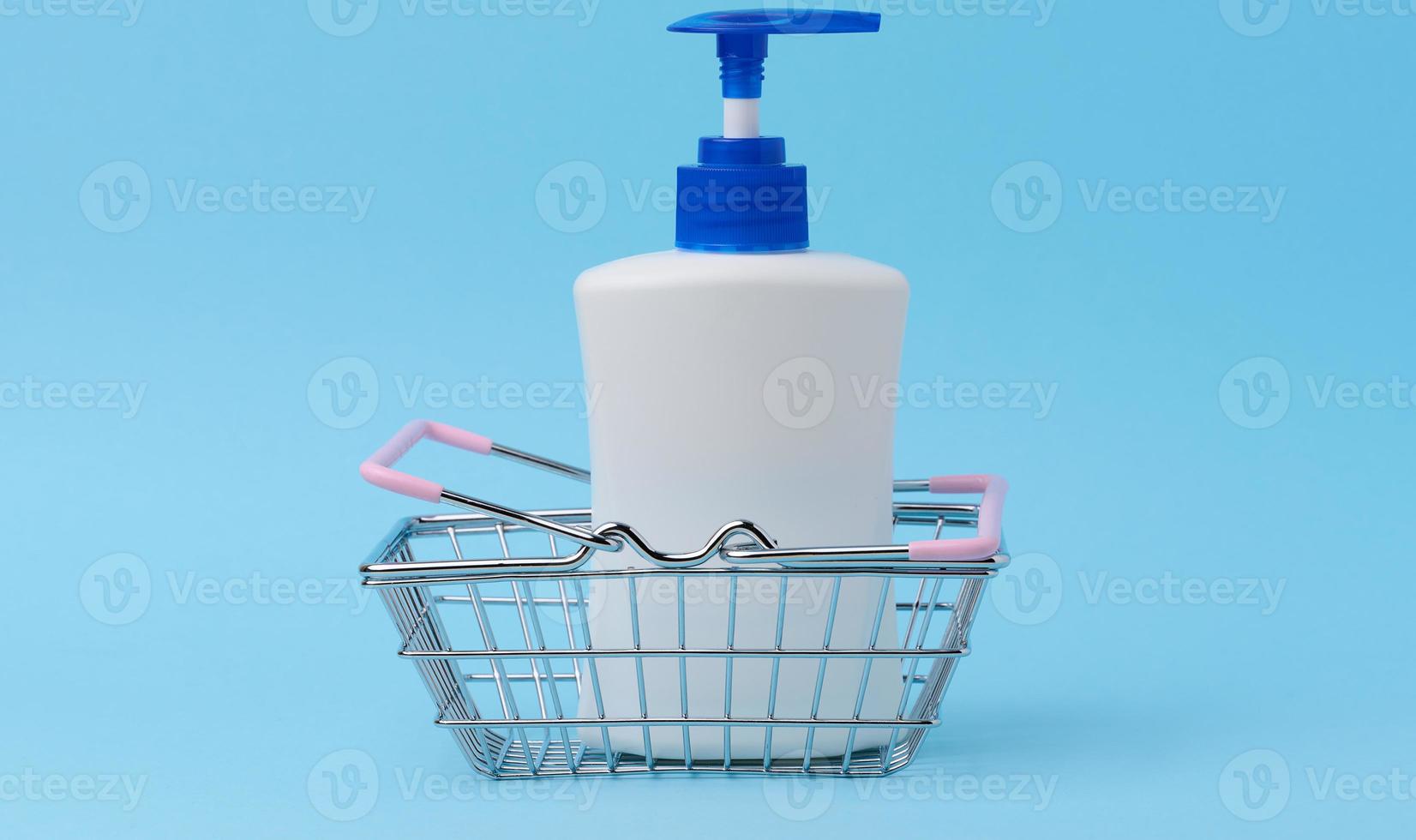 White plastic container with a pump for cosmetic liquid, liquid soap photo