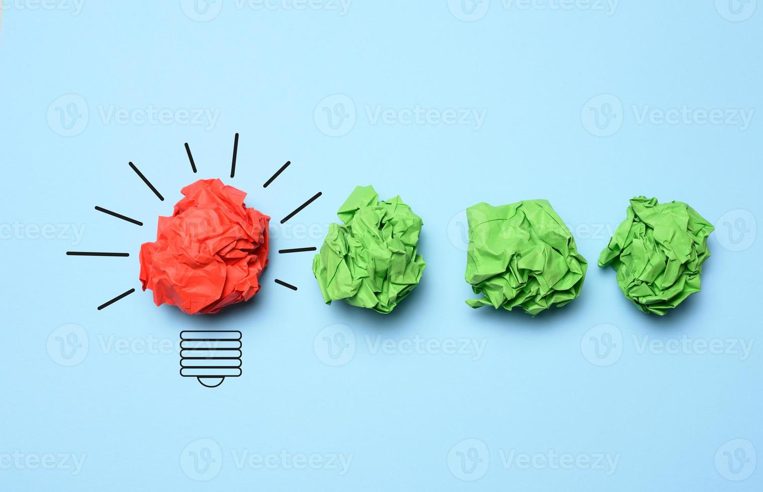 The concept of inspiration with new ideas, the search for creative solutions, crumpled sheets of paper in the form of balls on a blue background photo