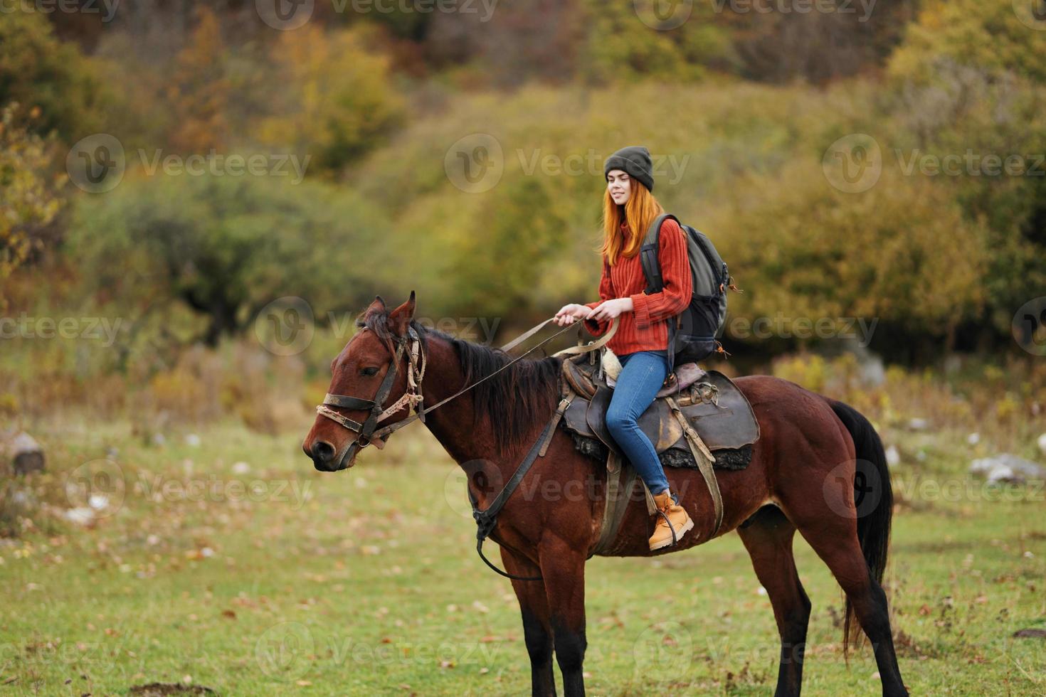 woman hiker riding a horse on nature travel photo