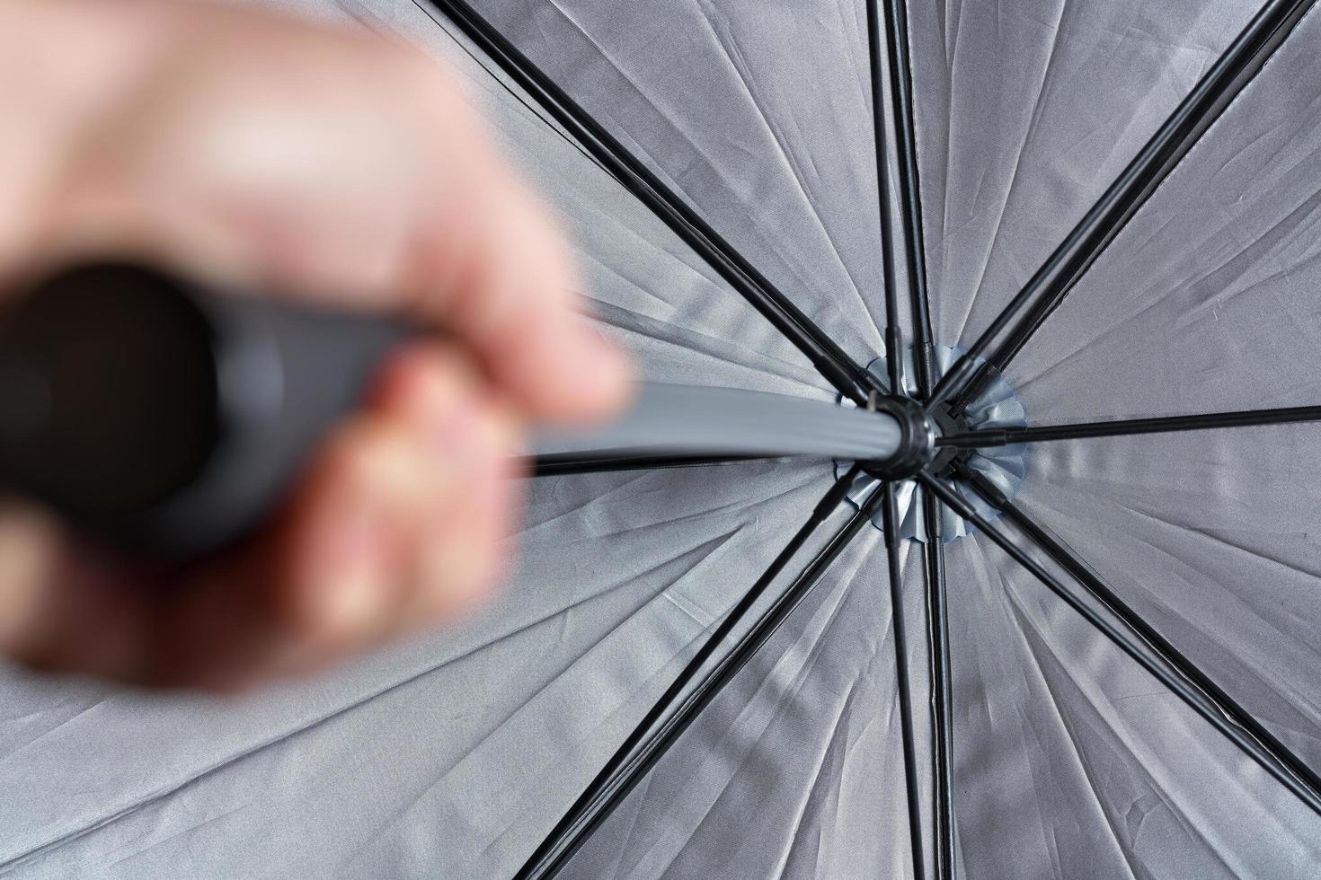 Open grey umbrella in hand photo