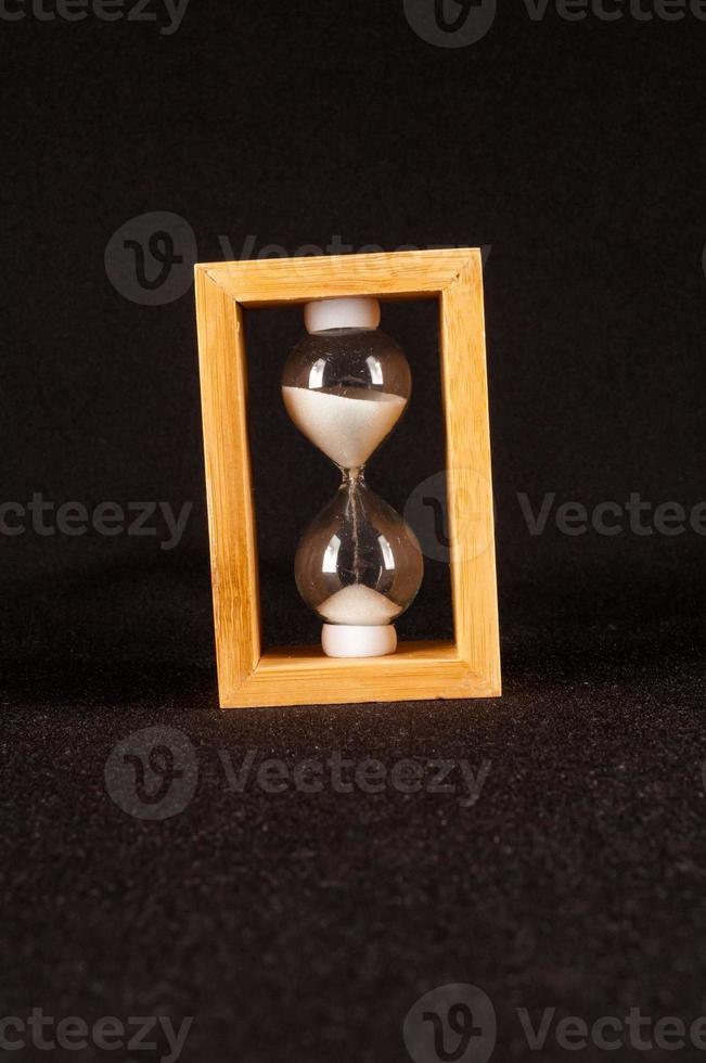 Hourglass on dark background photo