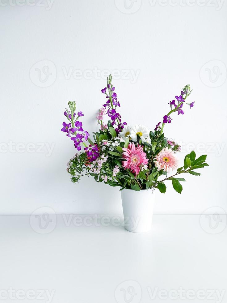 bouquet flowers in white vase. dianthus. daylight photo