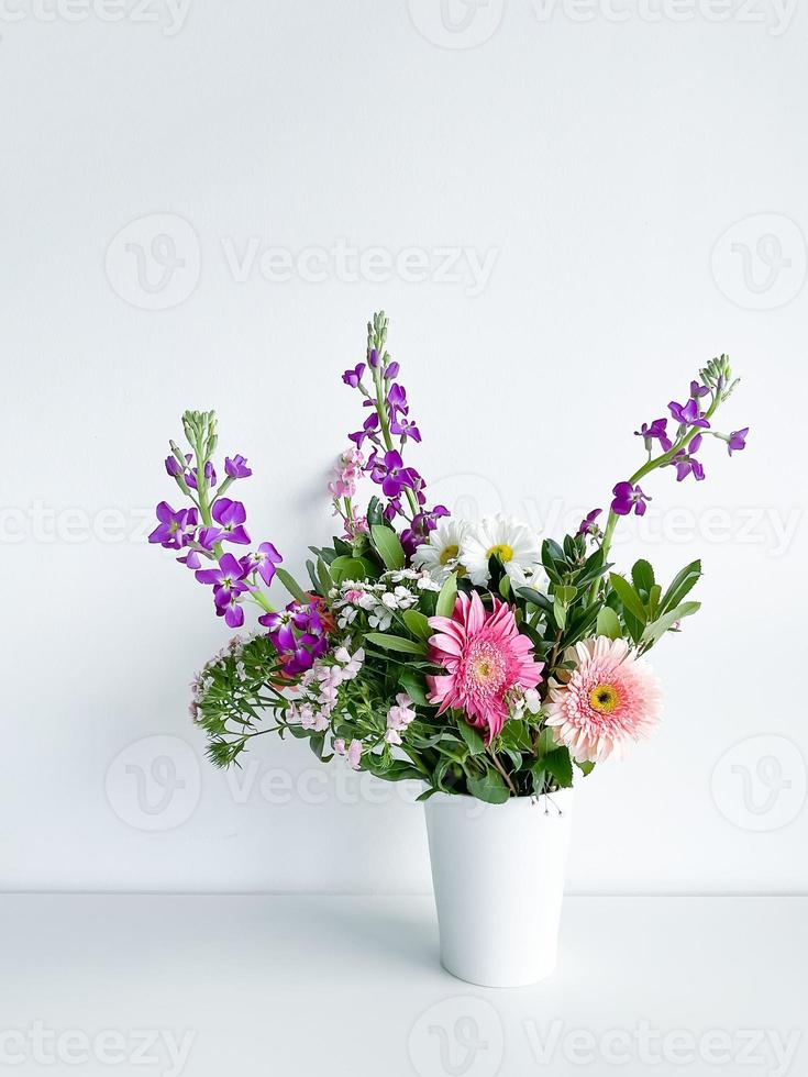 bouquet flowers in white vase. dianthus. daylight photo