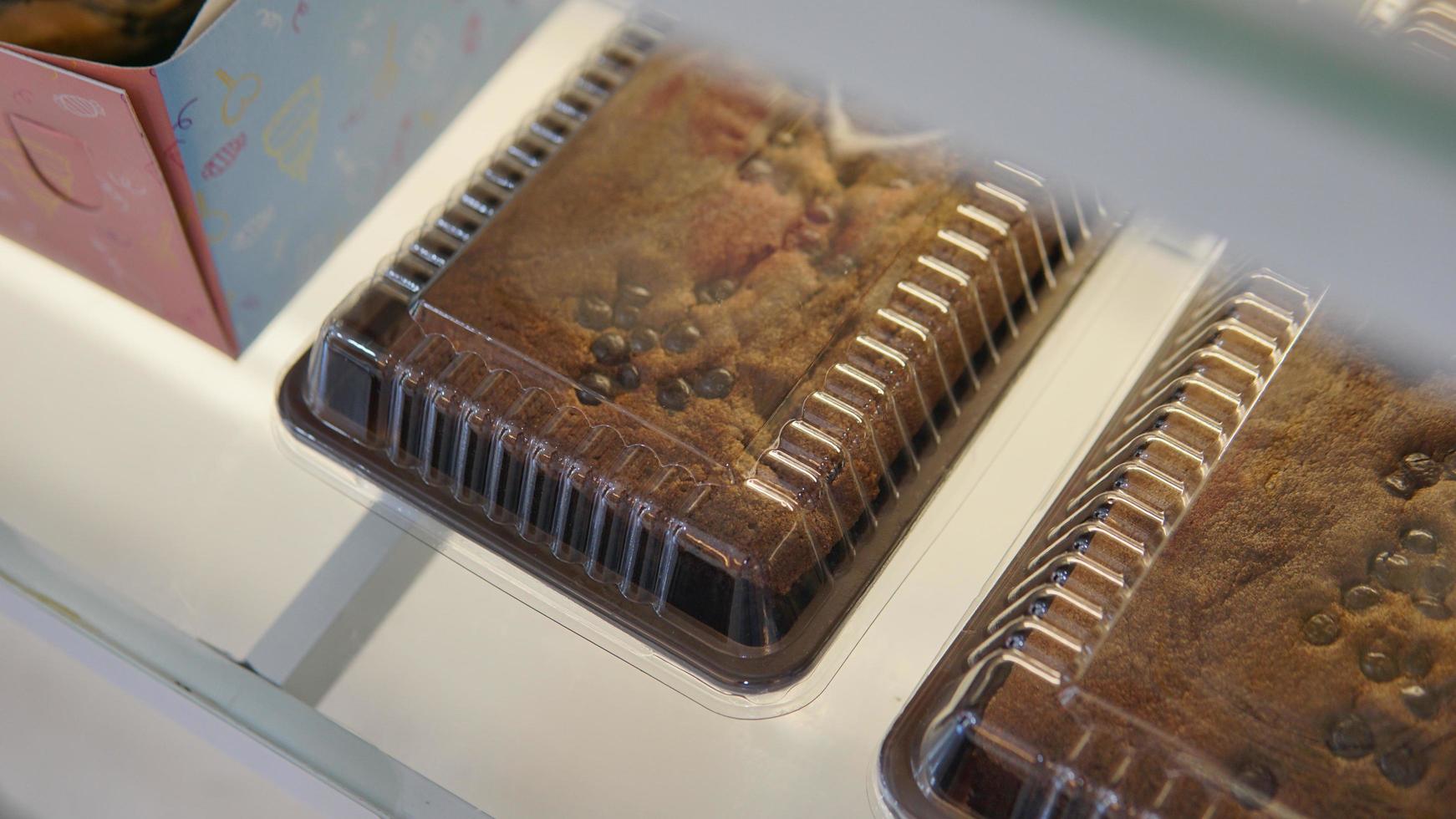 Chocolate cake with chocolate chips on a wooden background. Close-up. photo