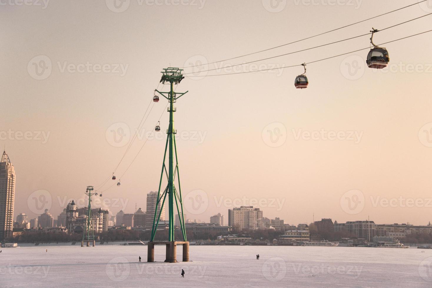 cableway lift across the Songhua River in winter, skyline of Songhuajiang river in Harbin photo