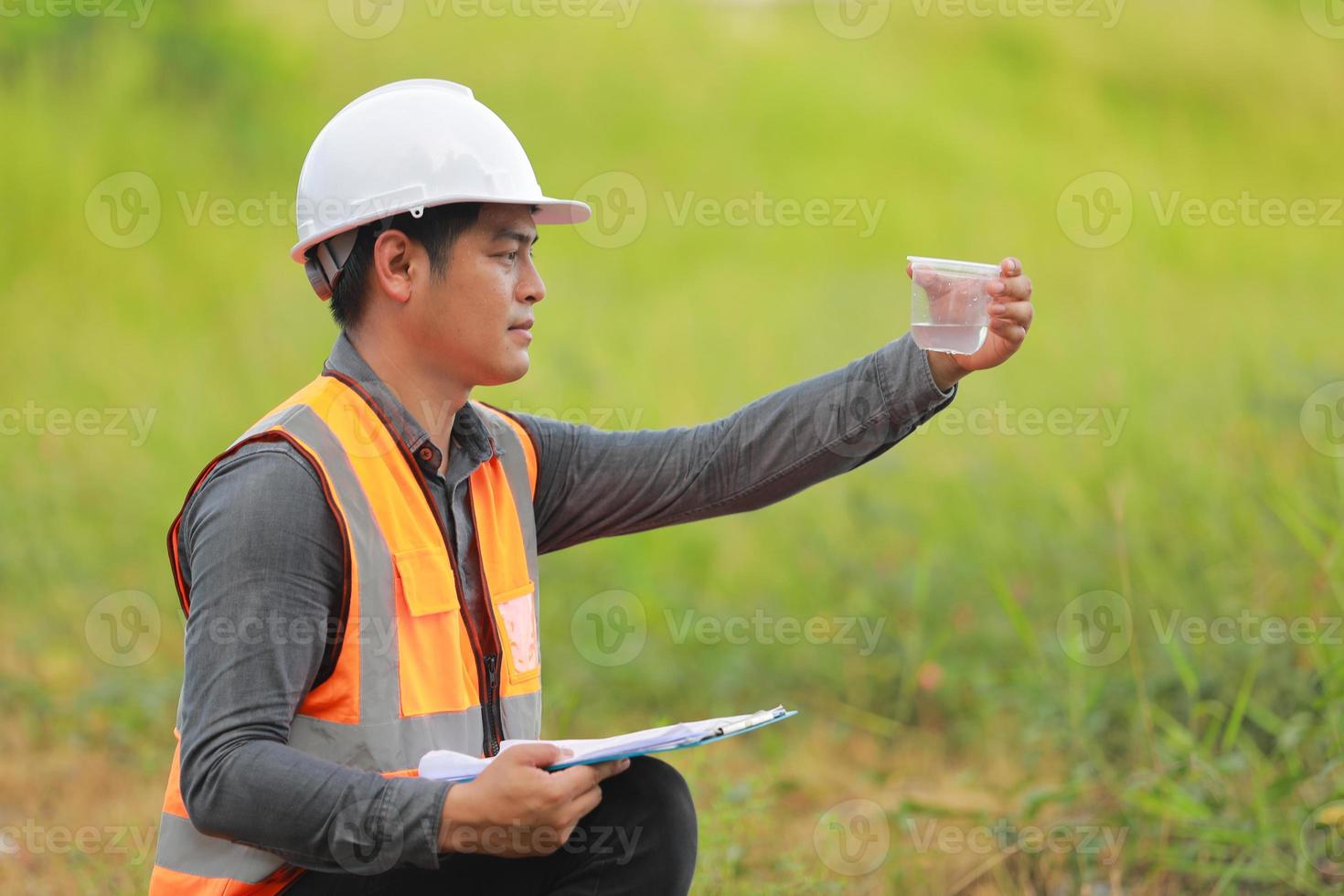 Environmental engineers work at water source to check for contaminants  in water sources and analysing water test results for reuse.World environment day concept. photo
