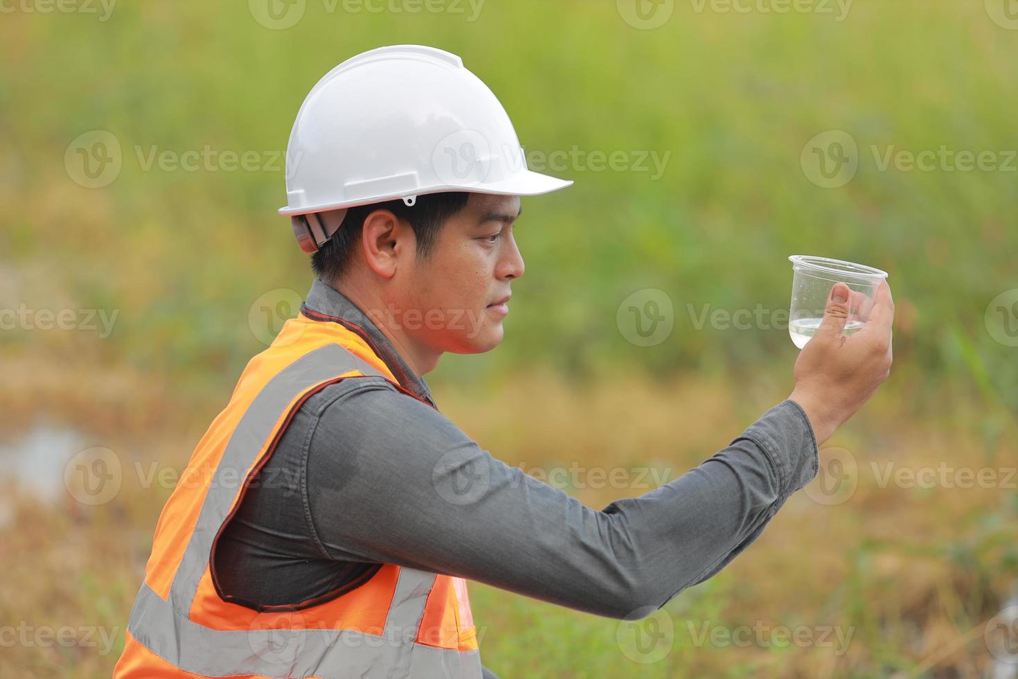 Environmental engineers work at water source to check for contaminants  in water sources and analysing water test results for reuse.World environment day concept. photo