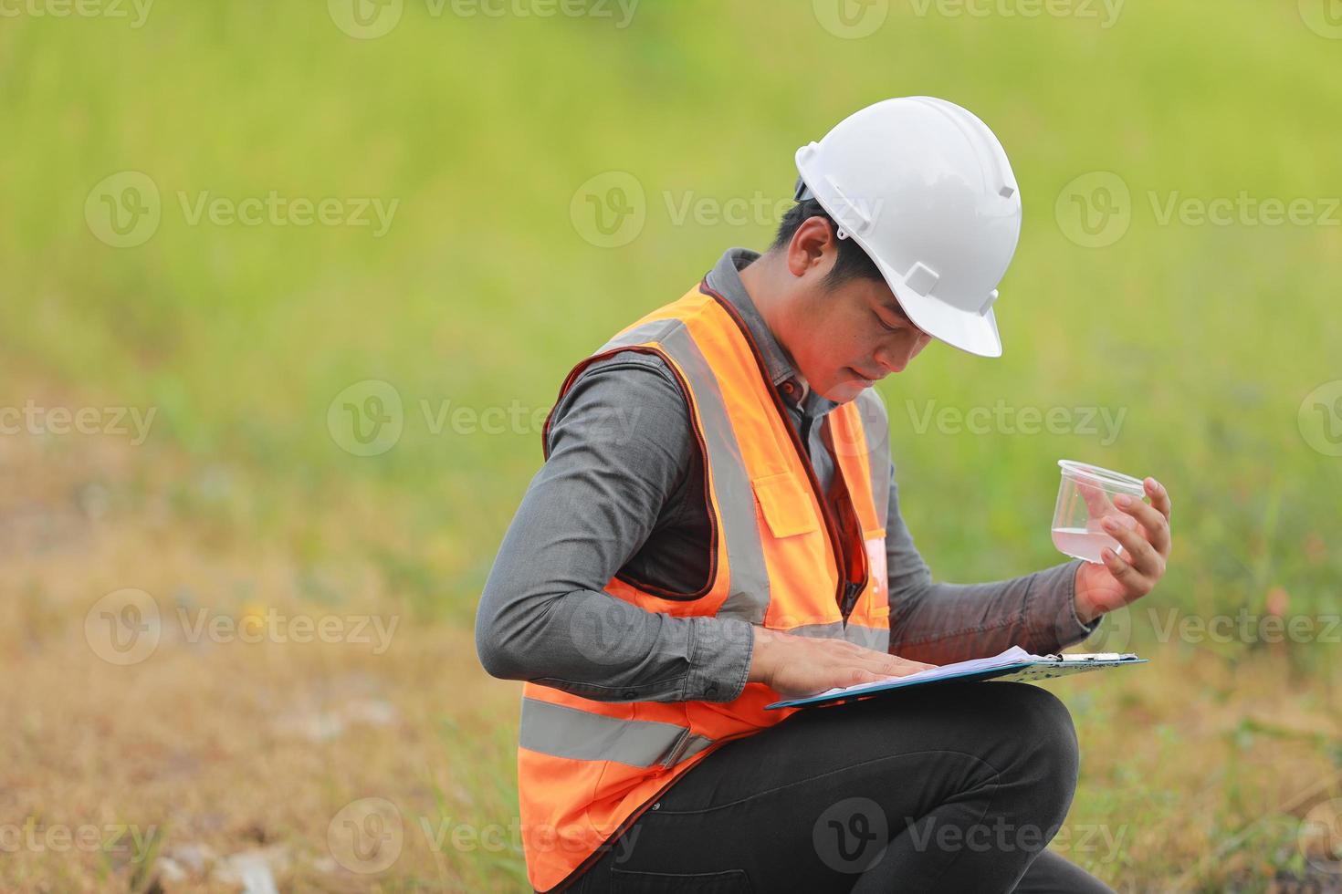 Environmental engineers work at water source to check for contaminants  in water sources and analysing water test results for reuse.World environment day concept. photo