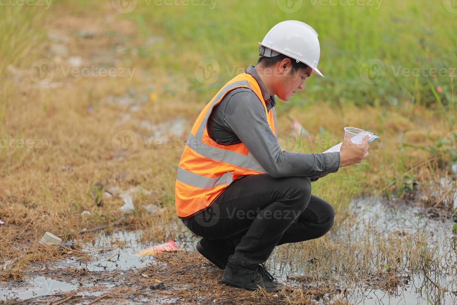 Environmental engineers work at water source to check for contaminants  in water sources and analysing water test results for reuse.World environment day concept. photo