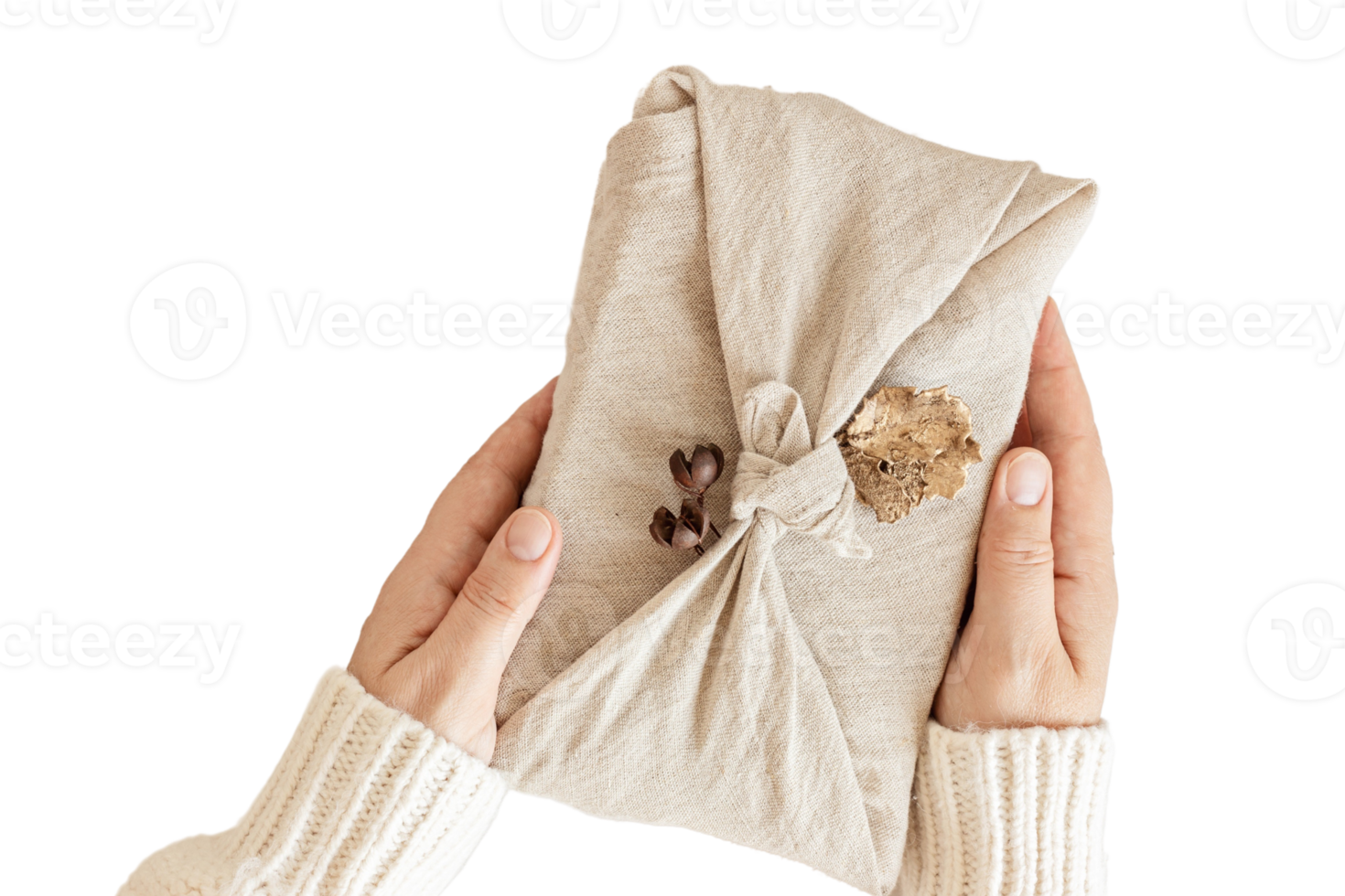 Beige cloth wrapped a gift held by a woman's hands isolated on a transparent background png