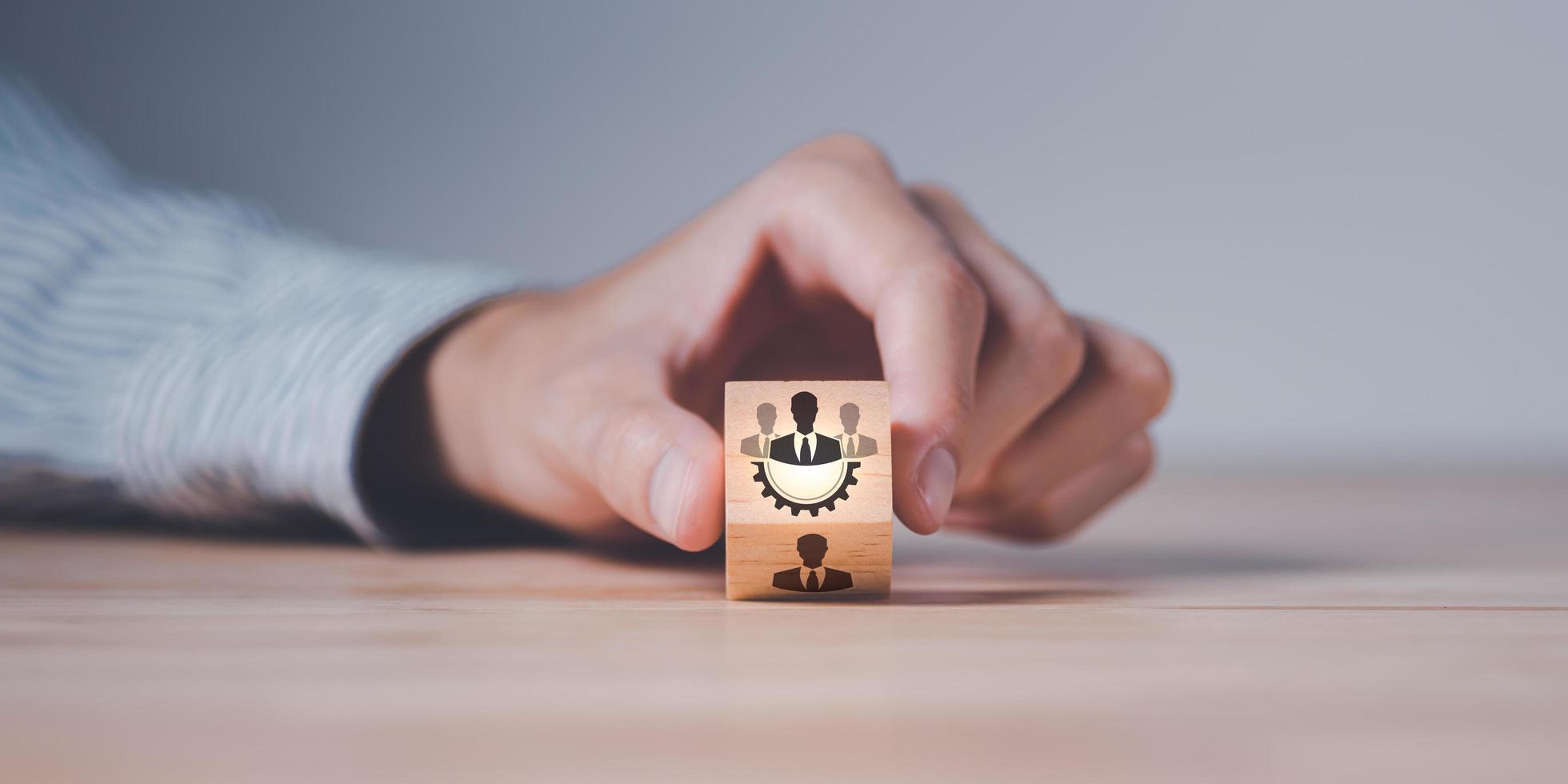 Businessman holding a wooden block ,team business success concept ,cooperation and support colleagues,brainstorming,corporate teamwork ,Successful business team ,Building a team to work together photo