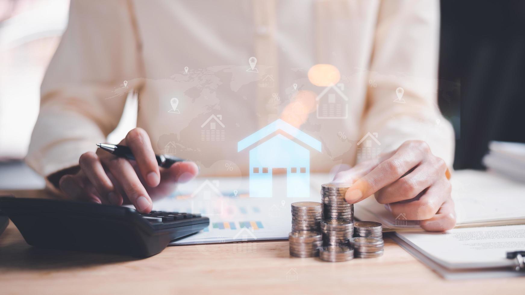 man holding coin and use calculator to calculate interest rate,real estate business,appraisal of property value,Finding a location to invest in real estate,Investment in real estate,houses and land photo