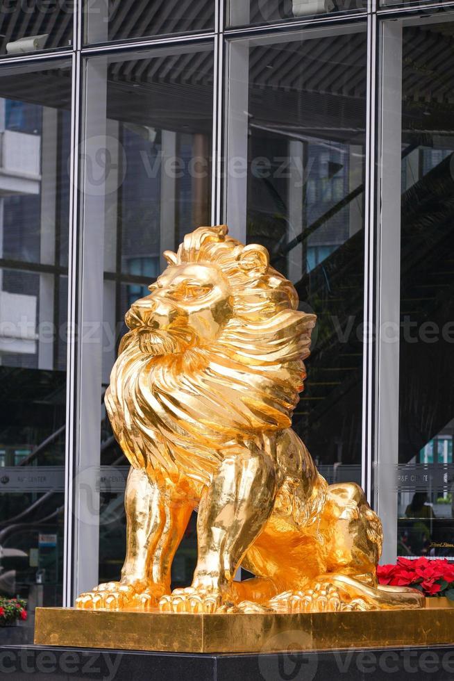 Gold Lion statue in front of building photo