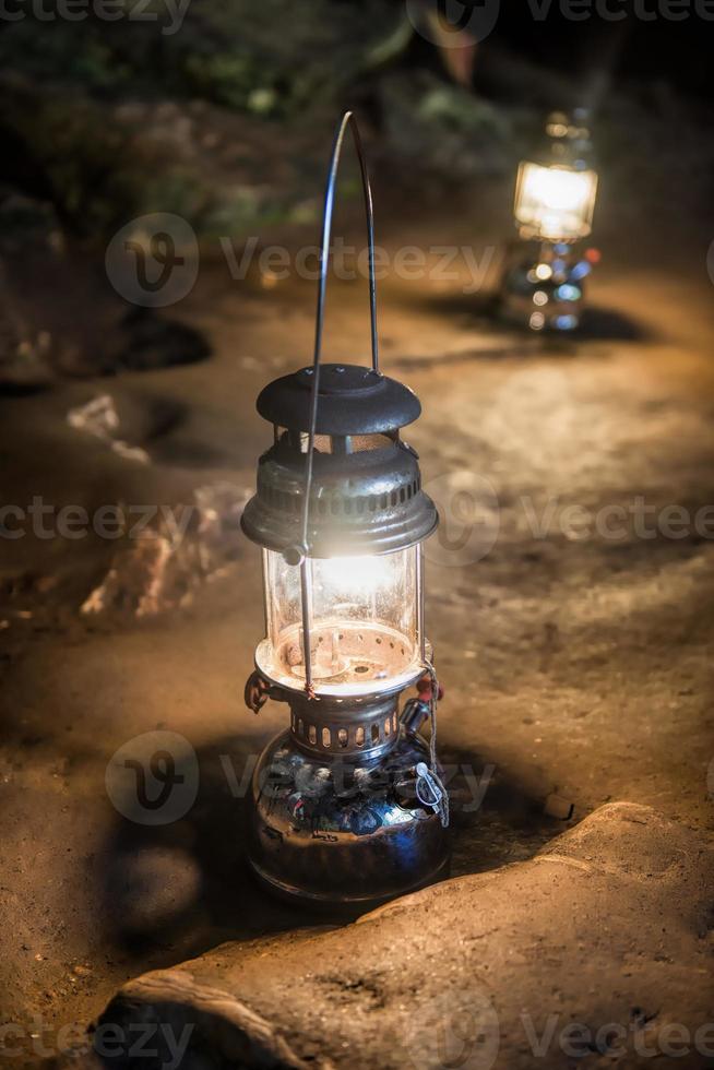 The old antique storm lantern in a cave photo