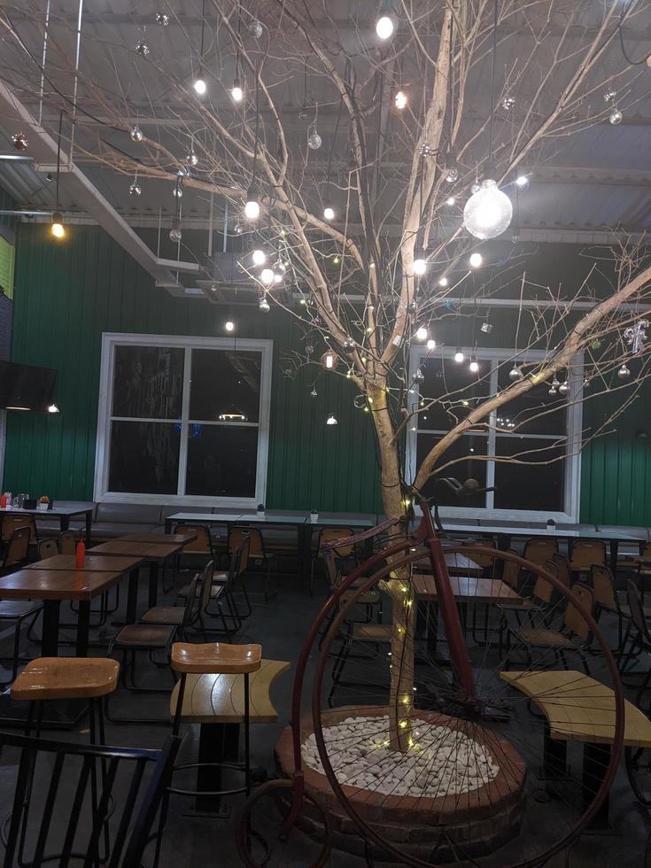Light Christmas tree on the middle restaurant. The photo is suitable to use for Christmas background, natal poster and content media.